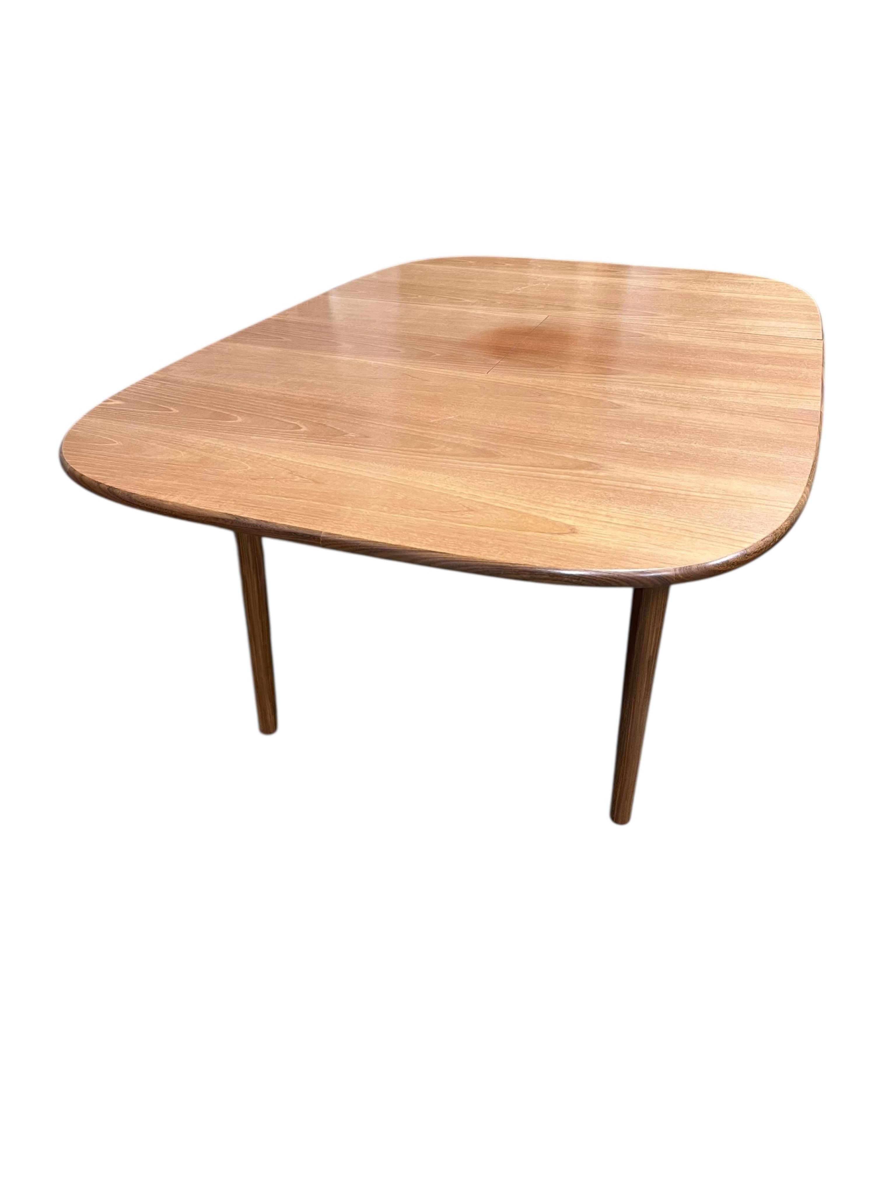 A mid century G Plan Fresco teak dining suite comprising dining table 184cm extended, depth 116cm, height 73cm, six chairs, two with arms and a four door sideboard, width 152cm